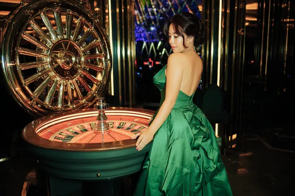 A close-up shot of golden coins falling around a spinning roulette wheel, representing immersive casino action at MC888.